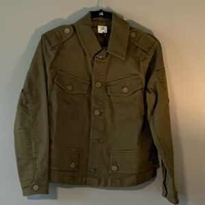 Bomber style jacket with epaulets, back zip, patch sleeve, unique button detail.